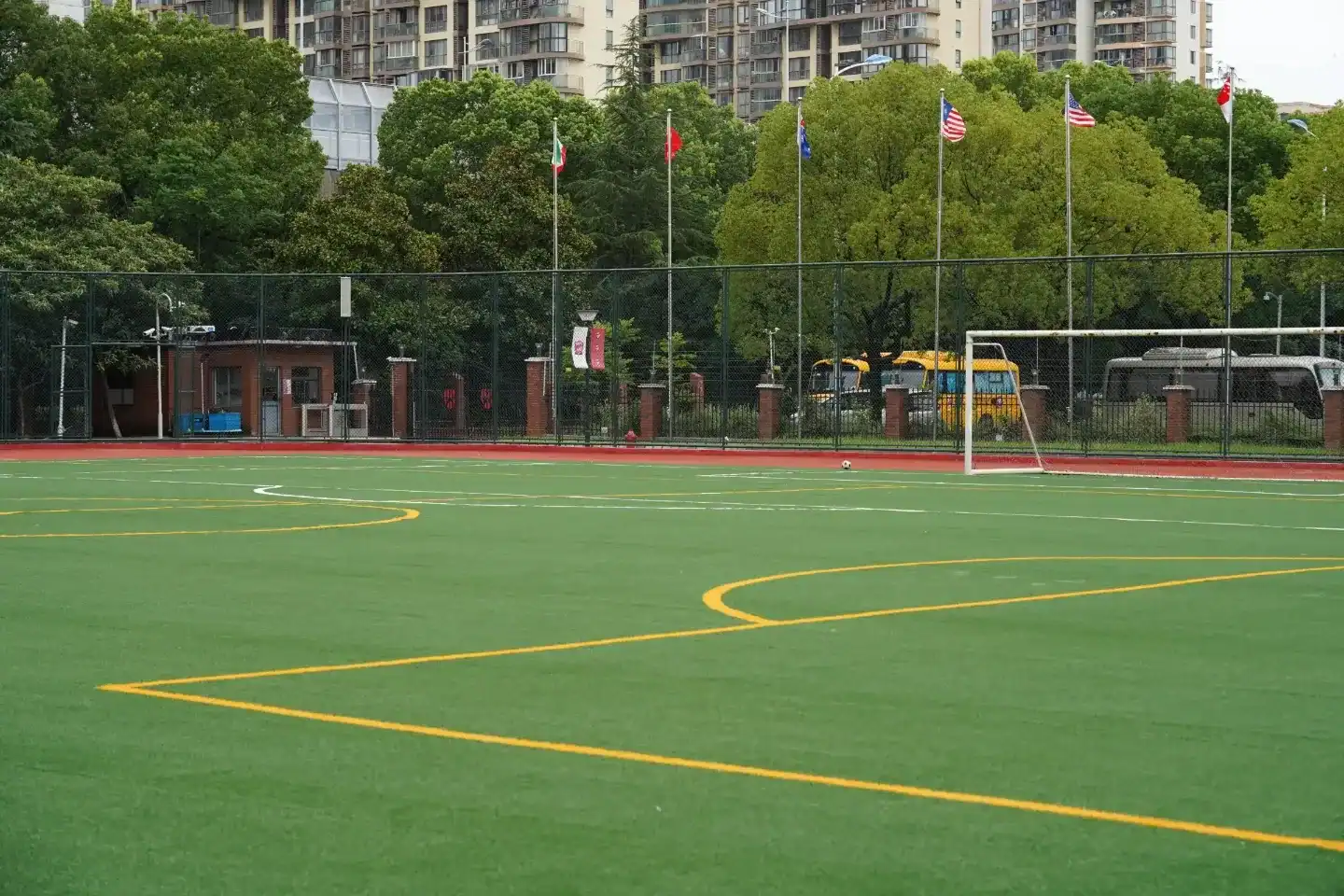 Sports field at Dulwich College Suzhou with vibrant green turf and colorful markings.