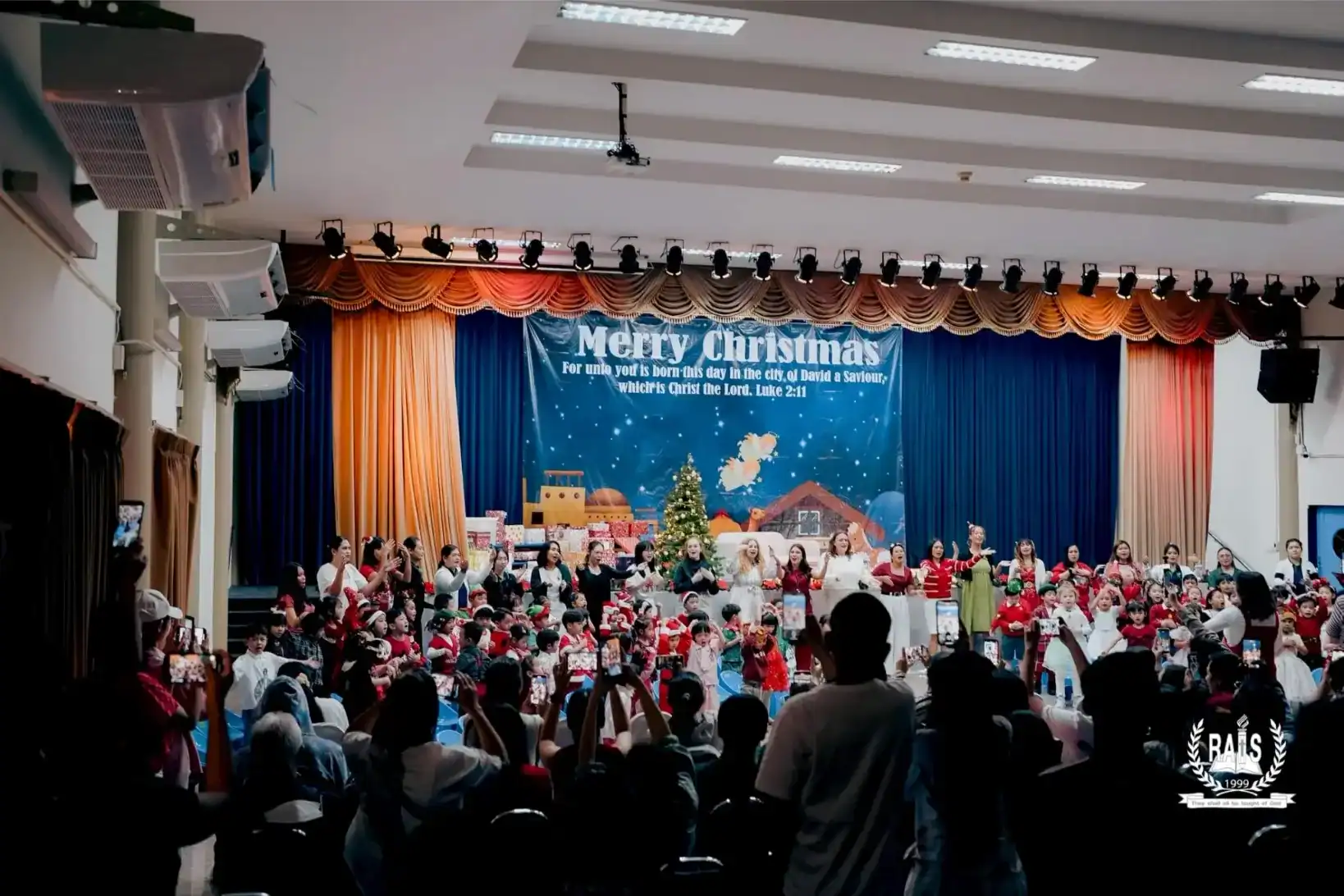 Christmas event at Ramkhamhaeng Advent International School with students performing on stage.