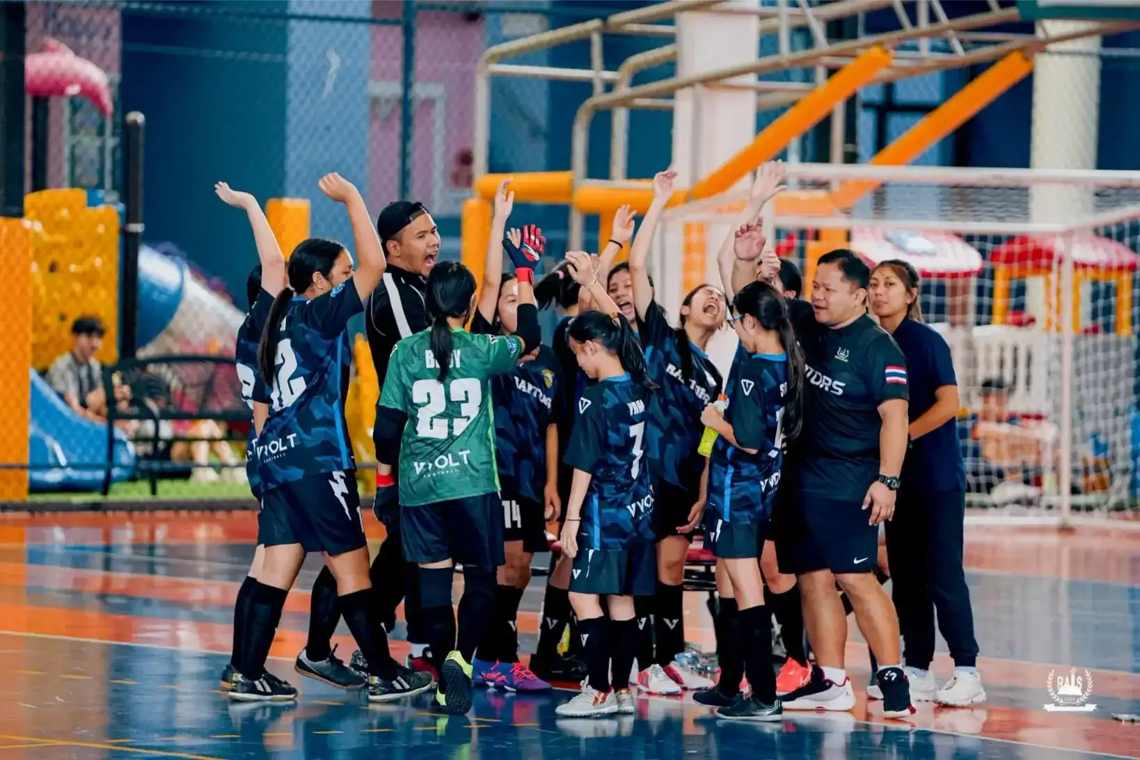 Girls' soccer team celebrating victory at World Schools tournament.