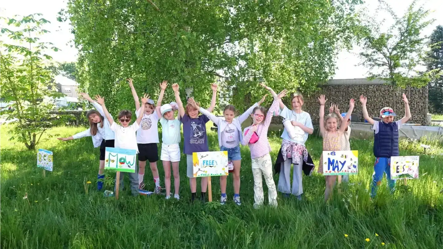 Group of children outdoors at St George's International School Luxembourg.