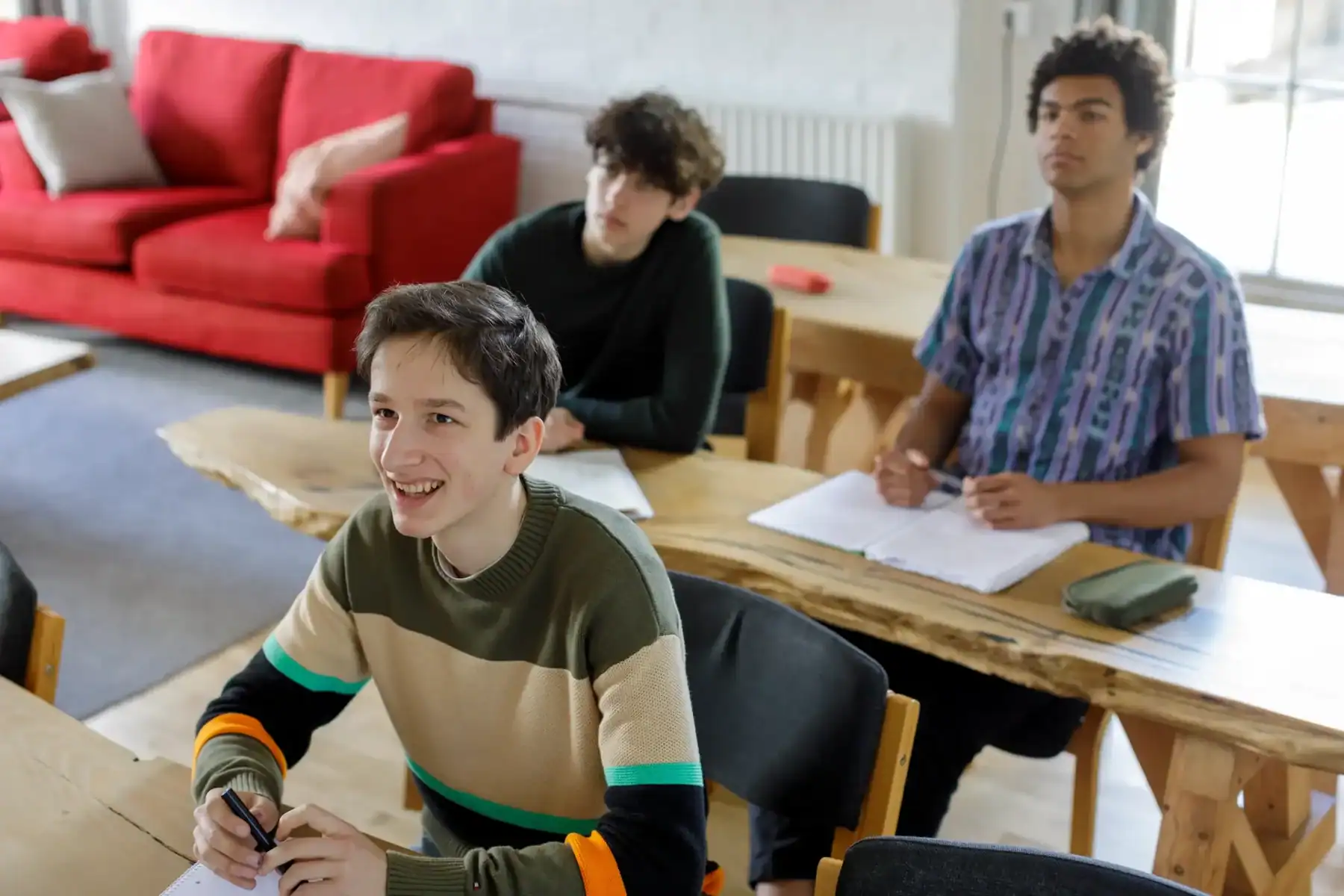 Bright students engaged in classroom activities at Brockwood Park School.