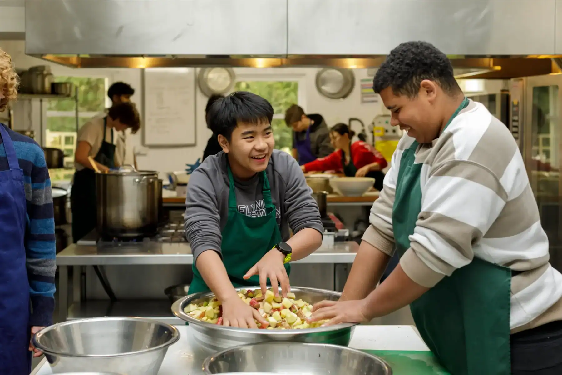 Young students cooking in a school kitchen.
