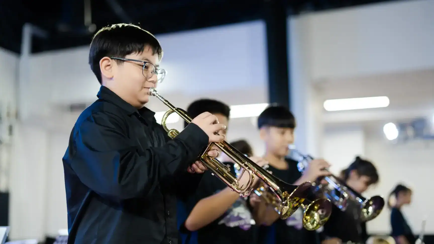 Students practicing trumpet instruments during music class at MYIS International School.