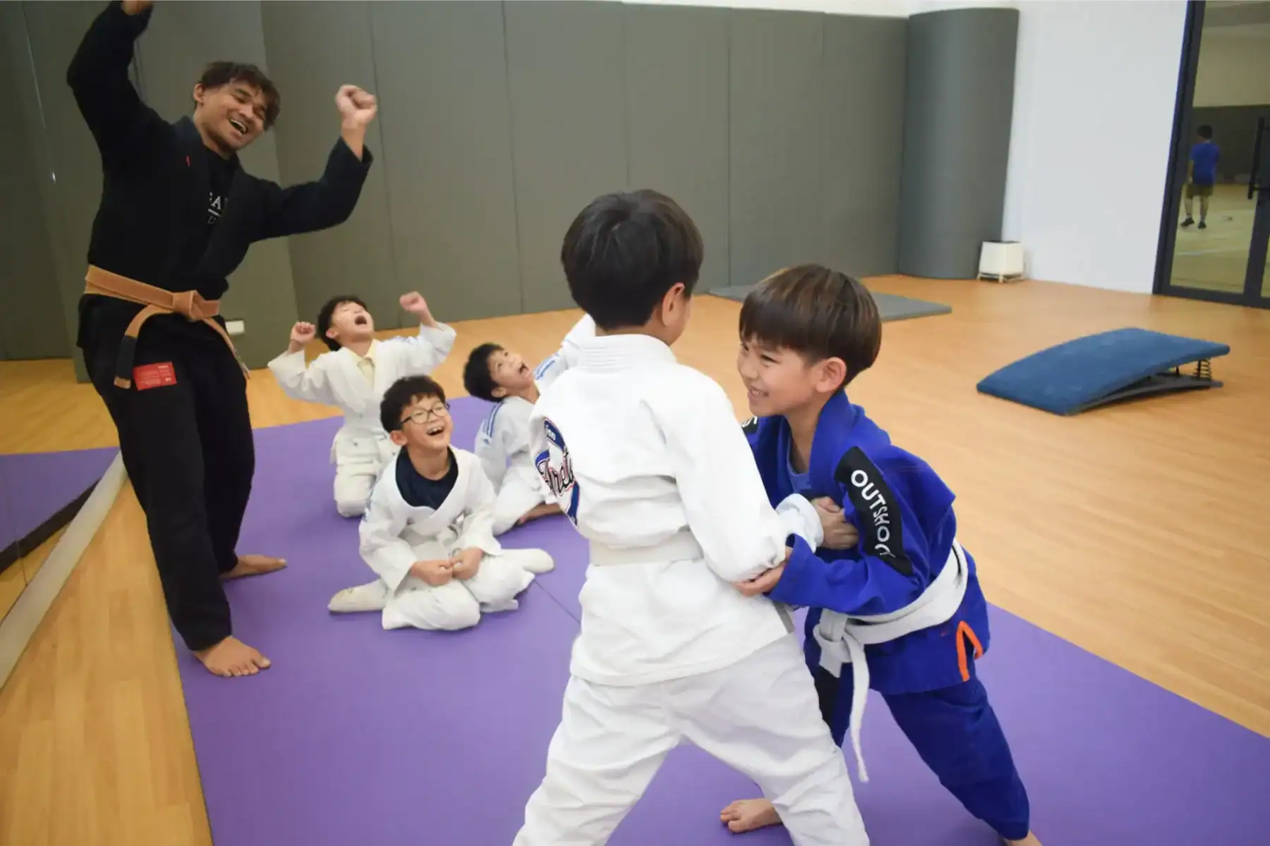 Children practicing martial arts in a classroom setting.