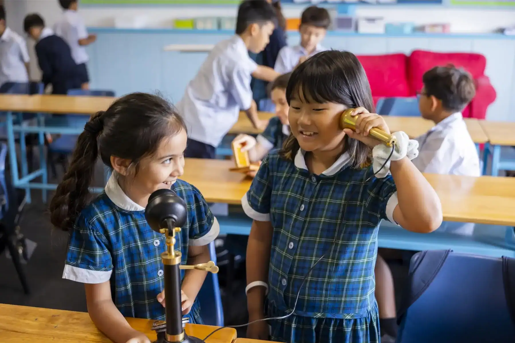 Young students conducting science experiments in a classroom setting.