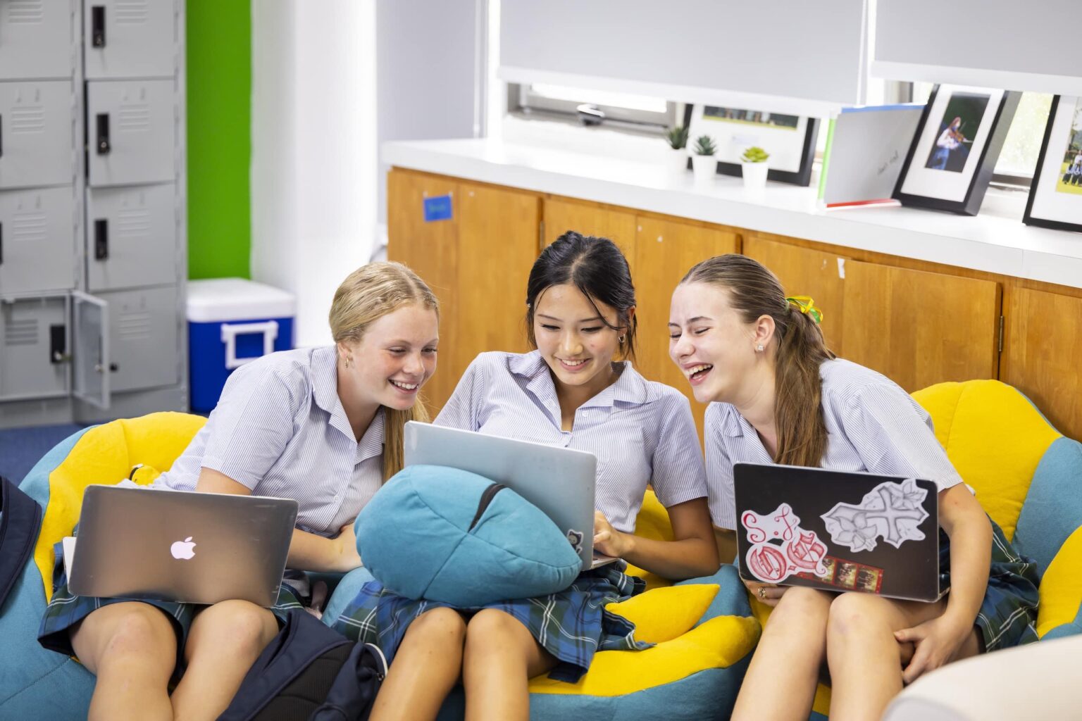 Students studying together with laptops in a modern classroom, promoting collaborative learning and.