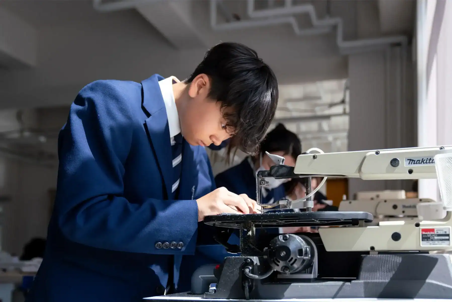 Student working with microscope in science lab at Harrow International School Appi Japan.