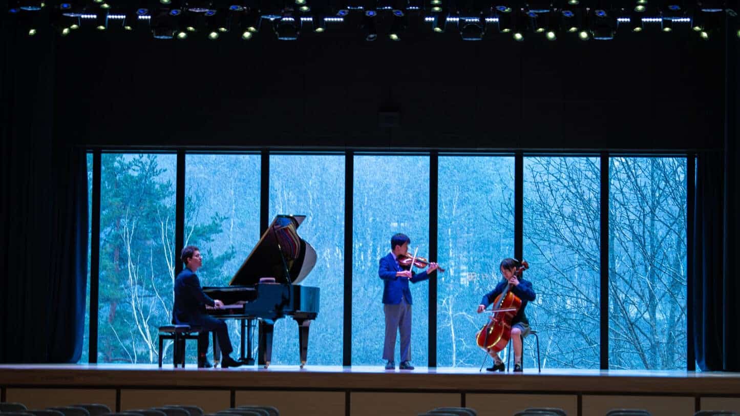 Students perform classical music on stage at Harrow International School Appi Japan.
