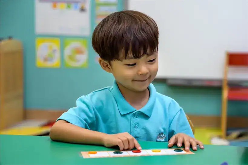 Young boy engaging in educational activity at The British School Warsaw.