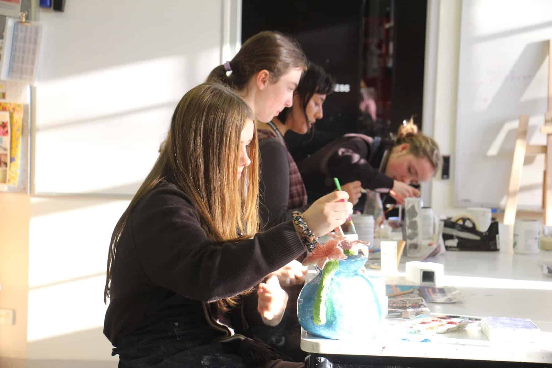 Students engaged in art project at Ivanhoe Grammar School classroom.