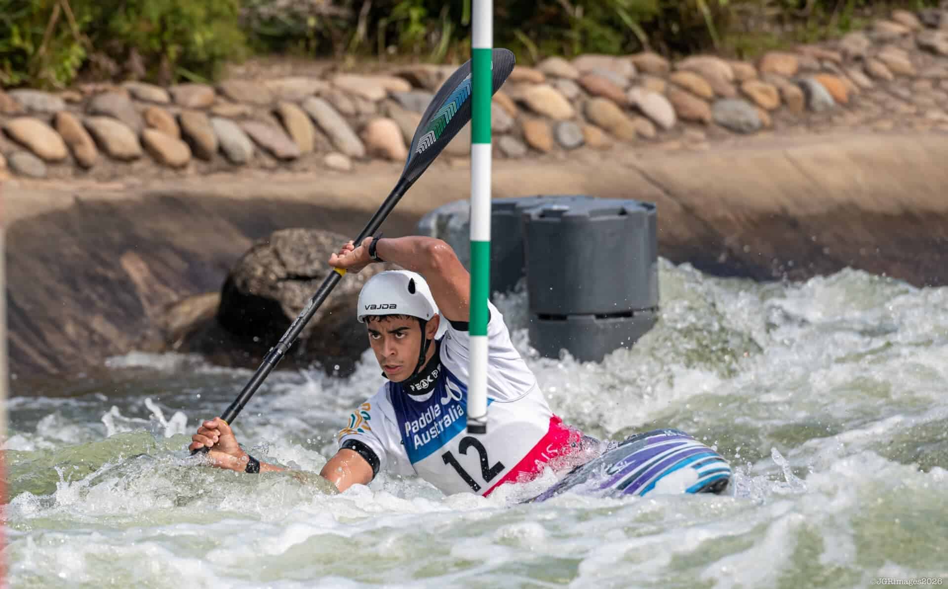 Young athlete competing in kayaking slalom at Ivanhoe Grammar School.