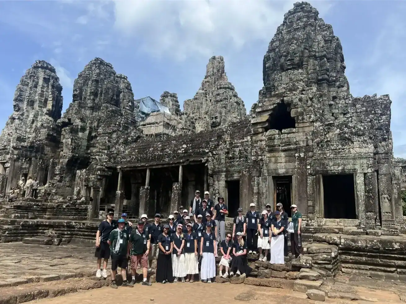 Group of students and teachers visiting Angkor Wat temple in Cambodia.