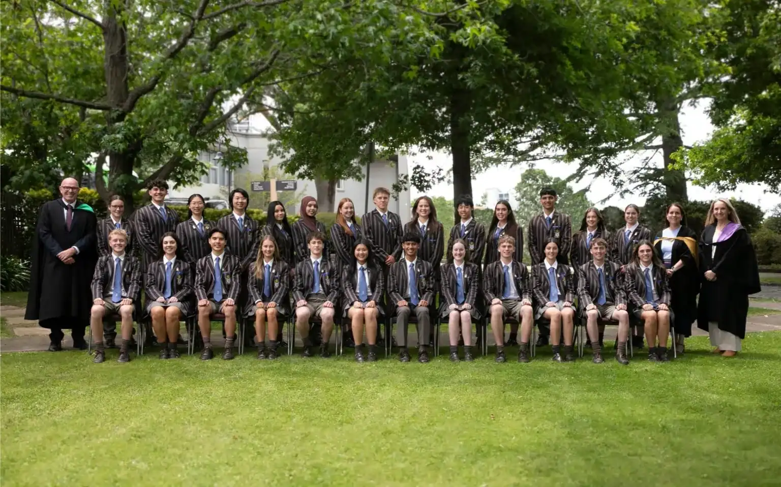 Group of students and teachers outdoors at Ivanhoe Grammar School.