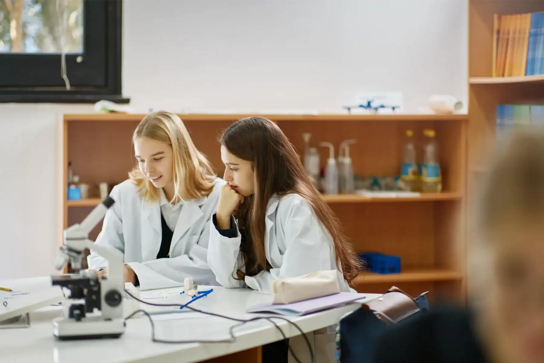Students conducting science experiment in classroom at Knightsbridge Schools International.