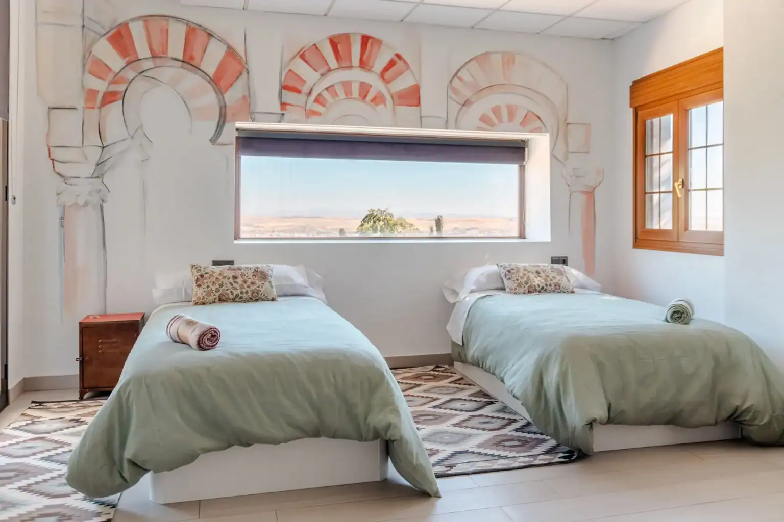 Modern twin bedroom at World Schools accommodation with scenic view and vibrant interior design.