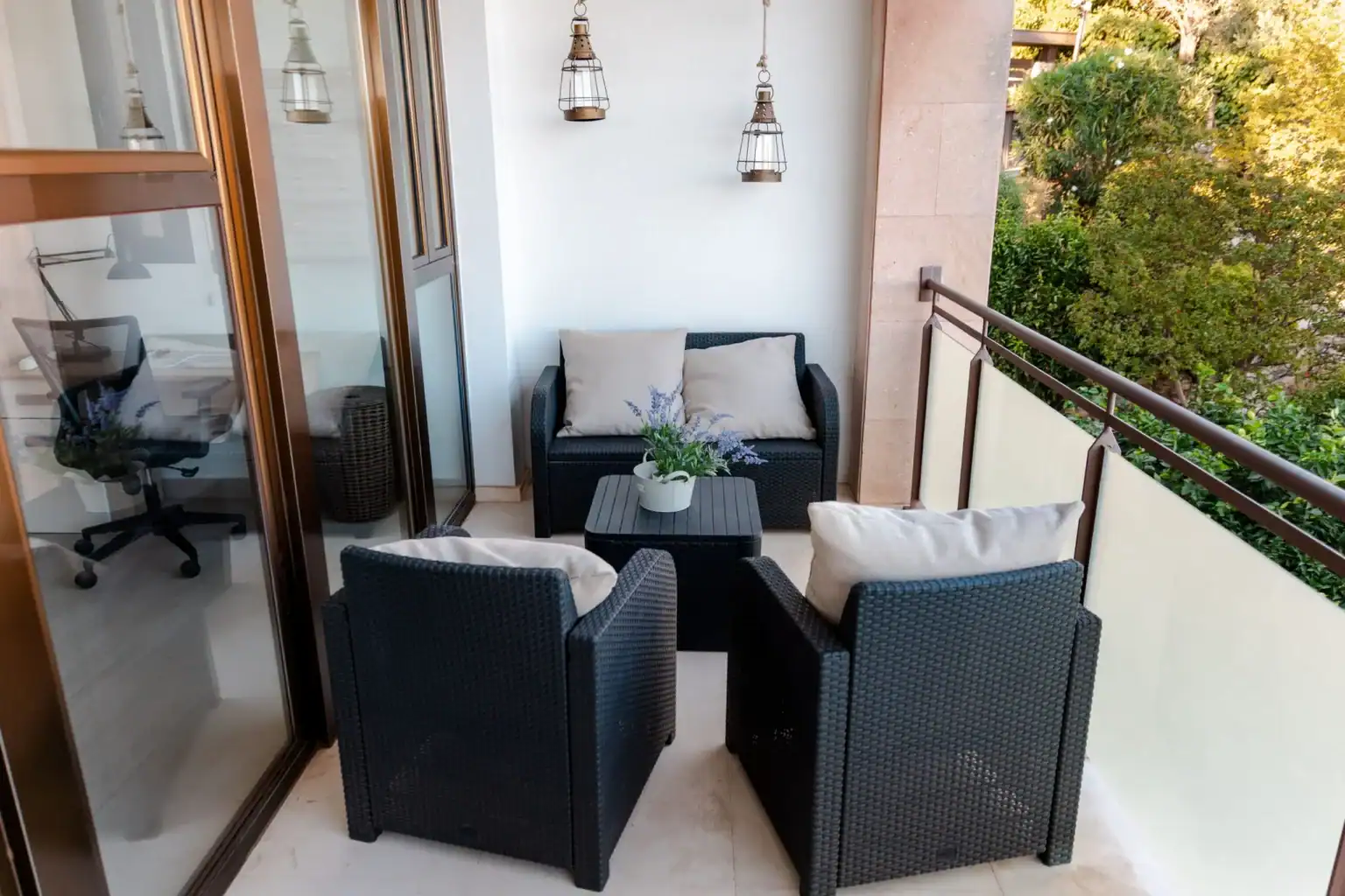 Contemporary balcony with wicker furniture and lush greenery, ideal for relaxing at World Schools.