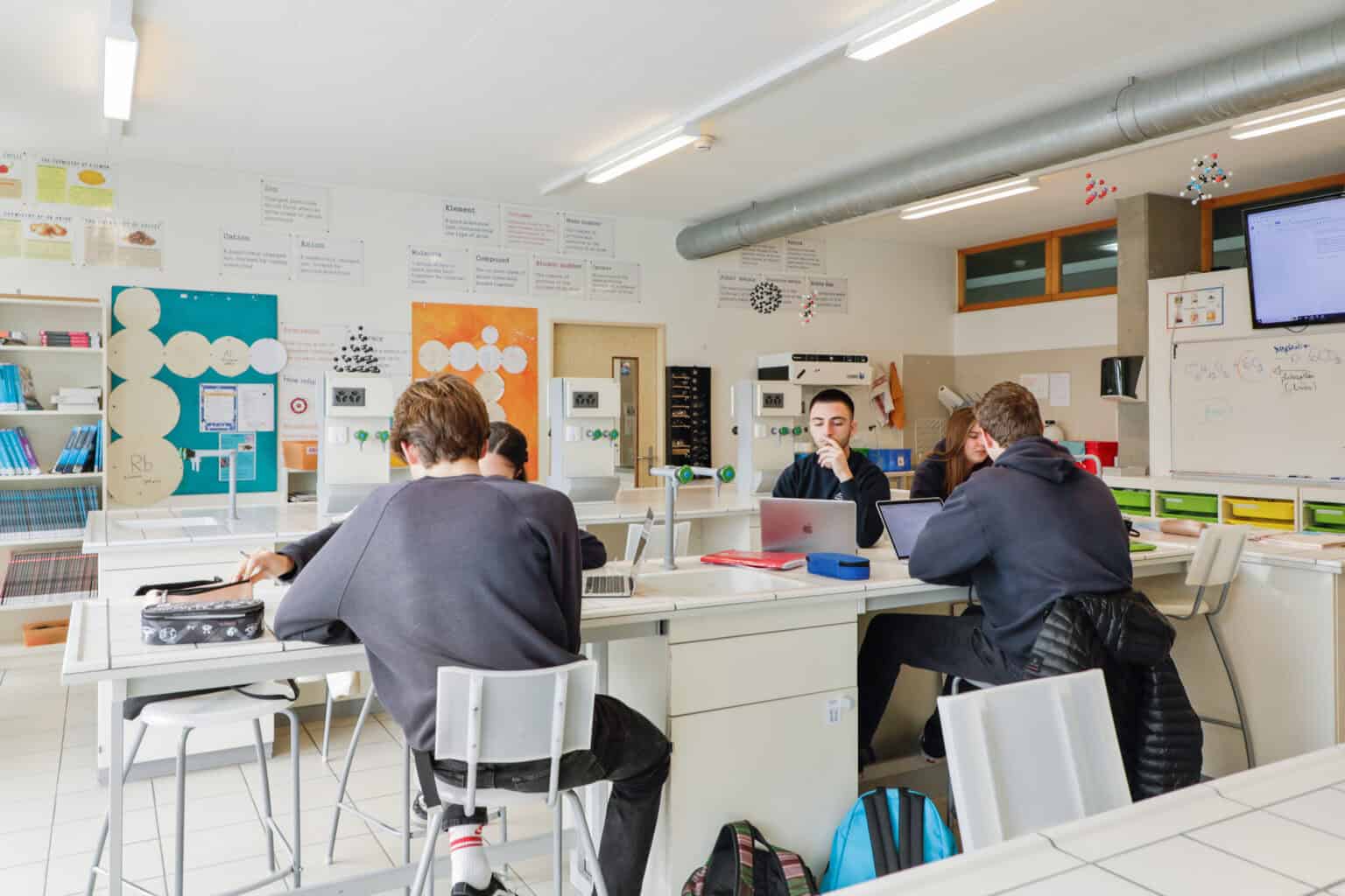 Modern science classroom at a world school with students studying and collaborating.
