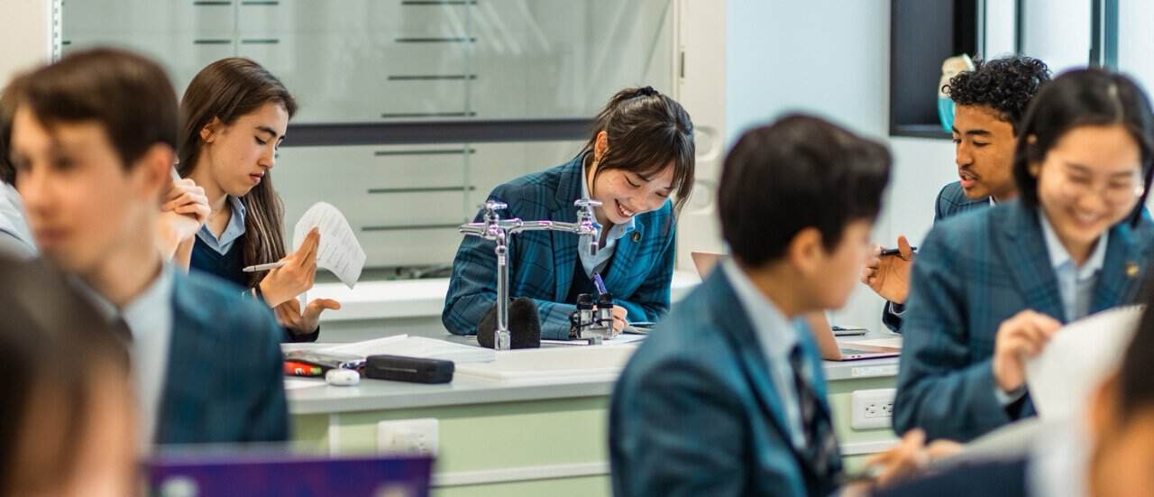 Modern classroom with diverse students engaged in learning activities.