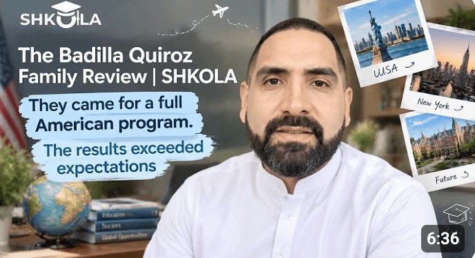 Man with a beard in a white shirt with world travel photos behind him.