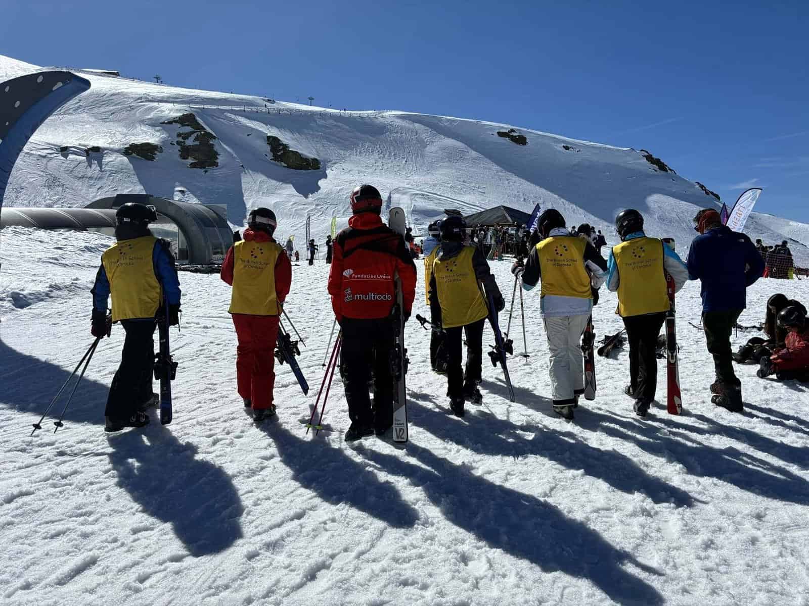 Group of students learning to ski on snowy mountain at World Schools ski resort.