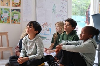 Students engaged in classroom activities at a world schools educational setting.