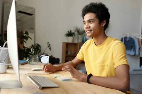 Student studying online at a computer for international school education.