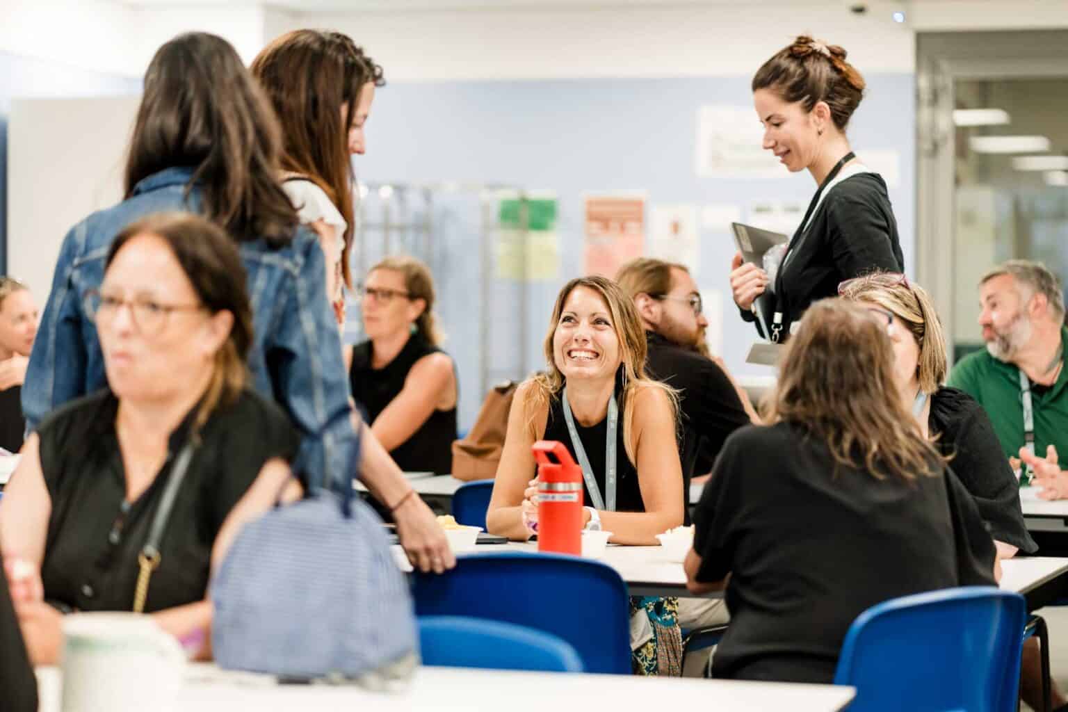 1. Diverse group of students and teachers at a World Schools conference networking together.