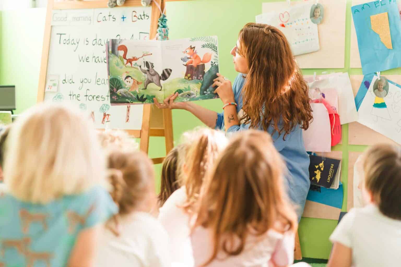 Bright classroom scene with a teacher reading a colorful storybook to engaged children.