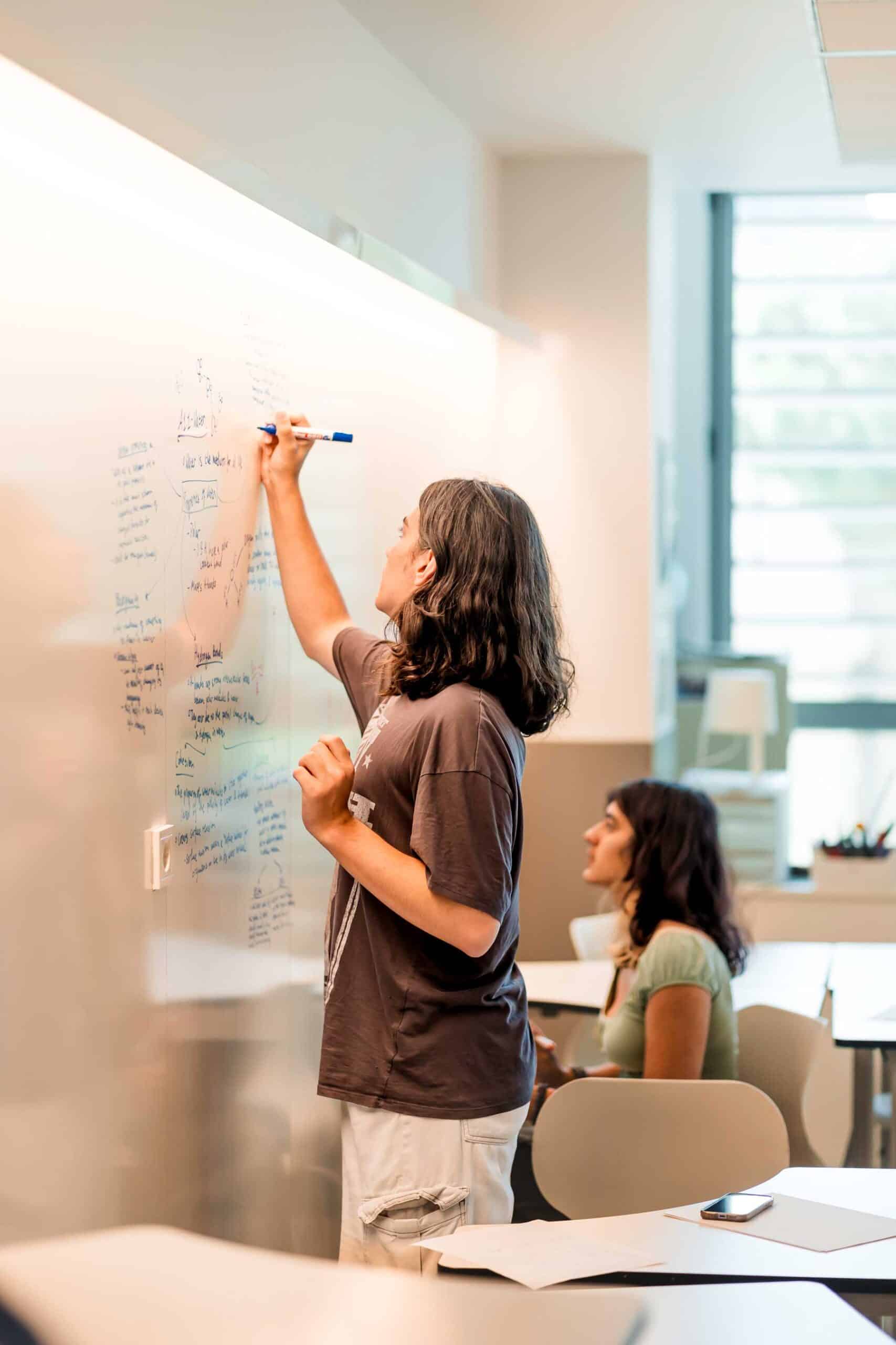 Diverse students collaborating creatively in a modern classroom at a world school.
