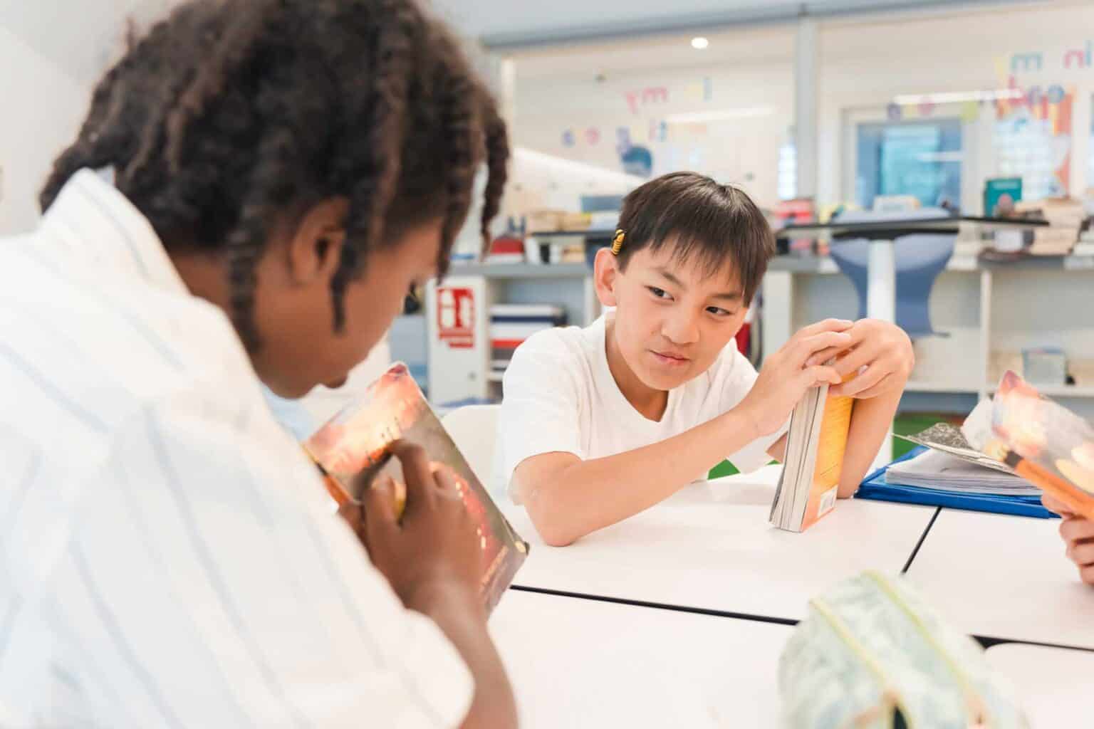 Innovative world school classroom with diverse students engaging in interactive learning activities.