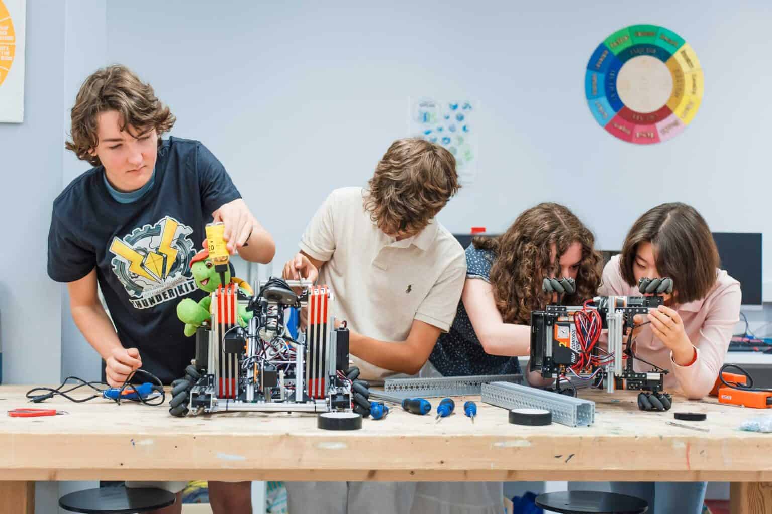 Robotics students working on building and programming STEM projects at World Schools.