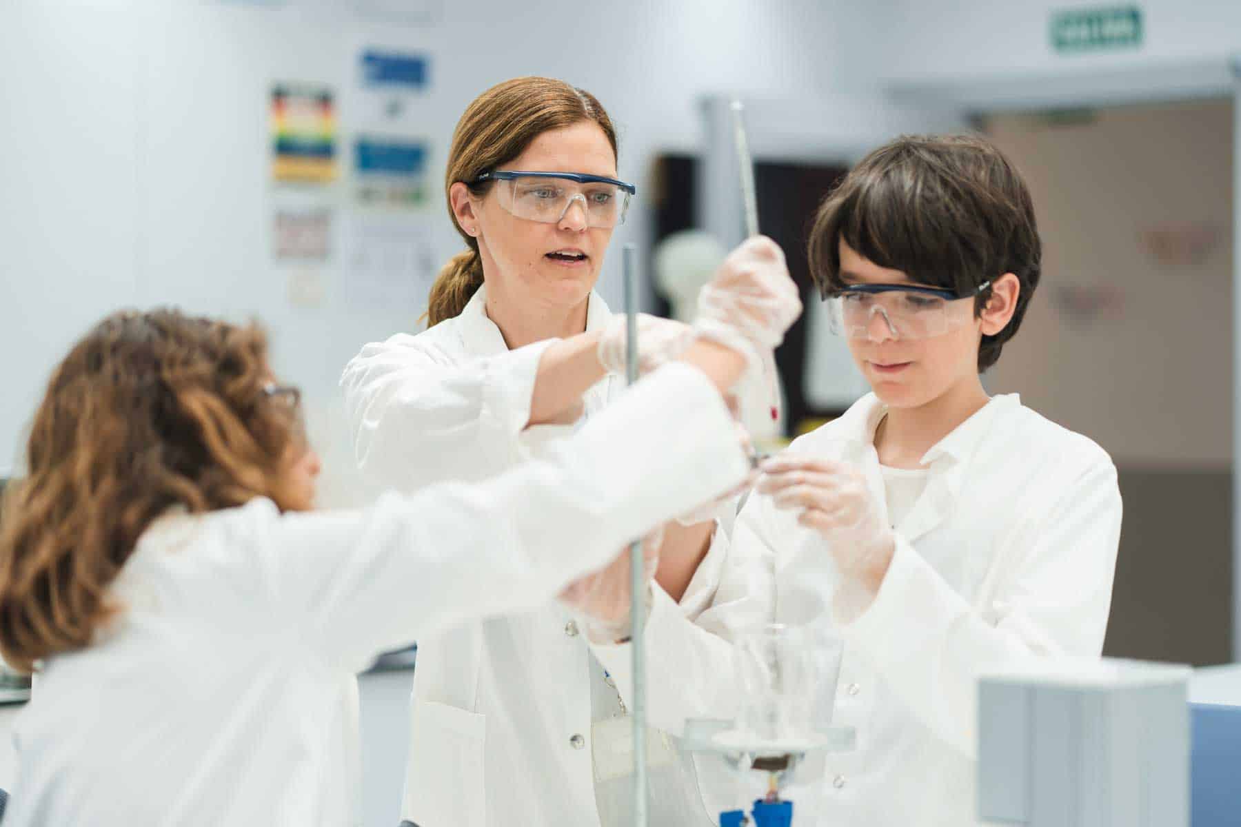 Innovative science lab with children conducting experiments under teacher supervision at World Schools.