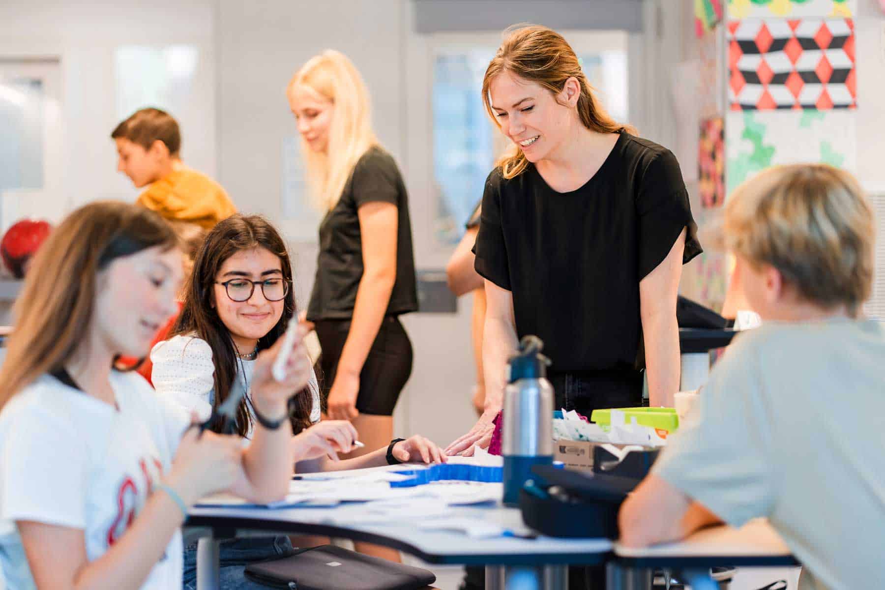 Innovative school classroom with engaged students and dedicated teacher promoting global education at World Schools.