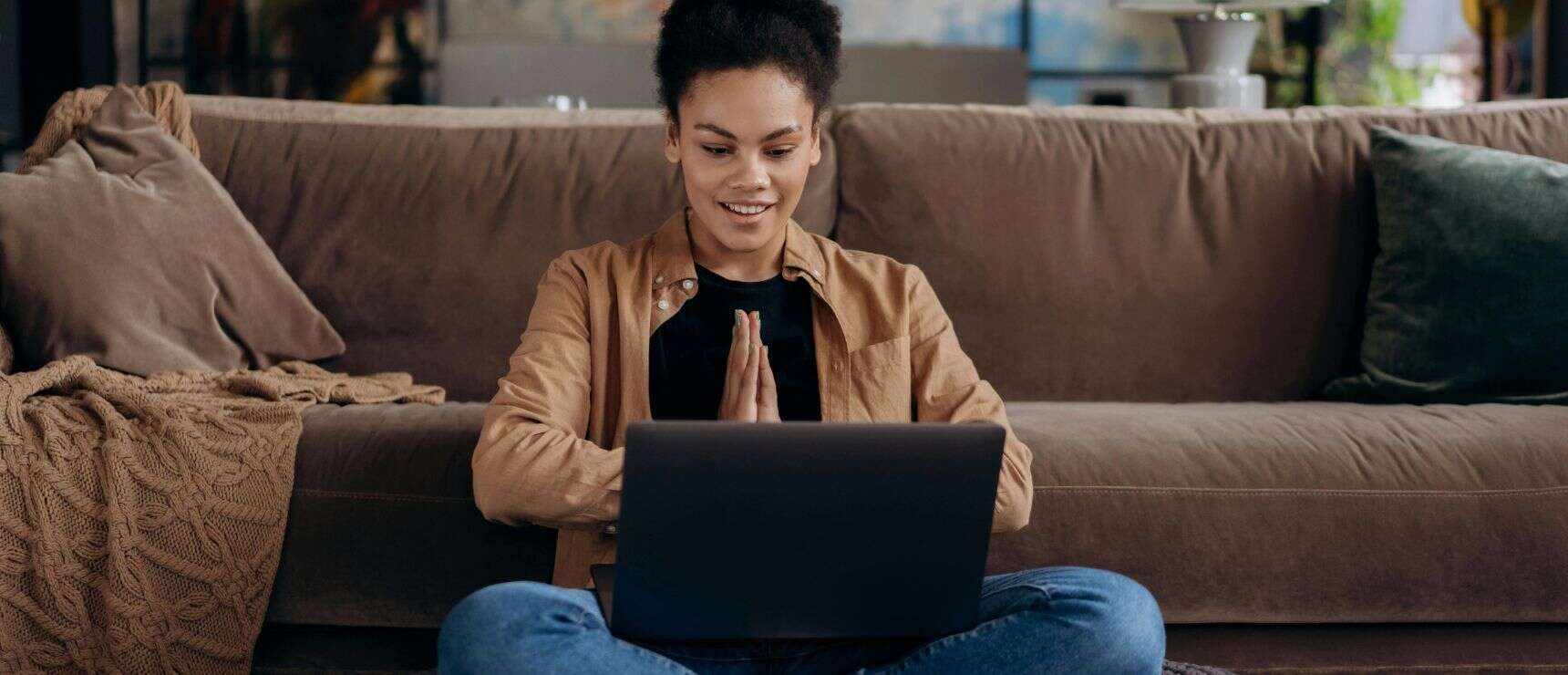 Enjoying online learning at home with a happy student using a laptop for education.