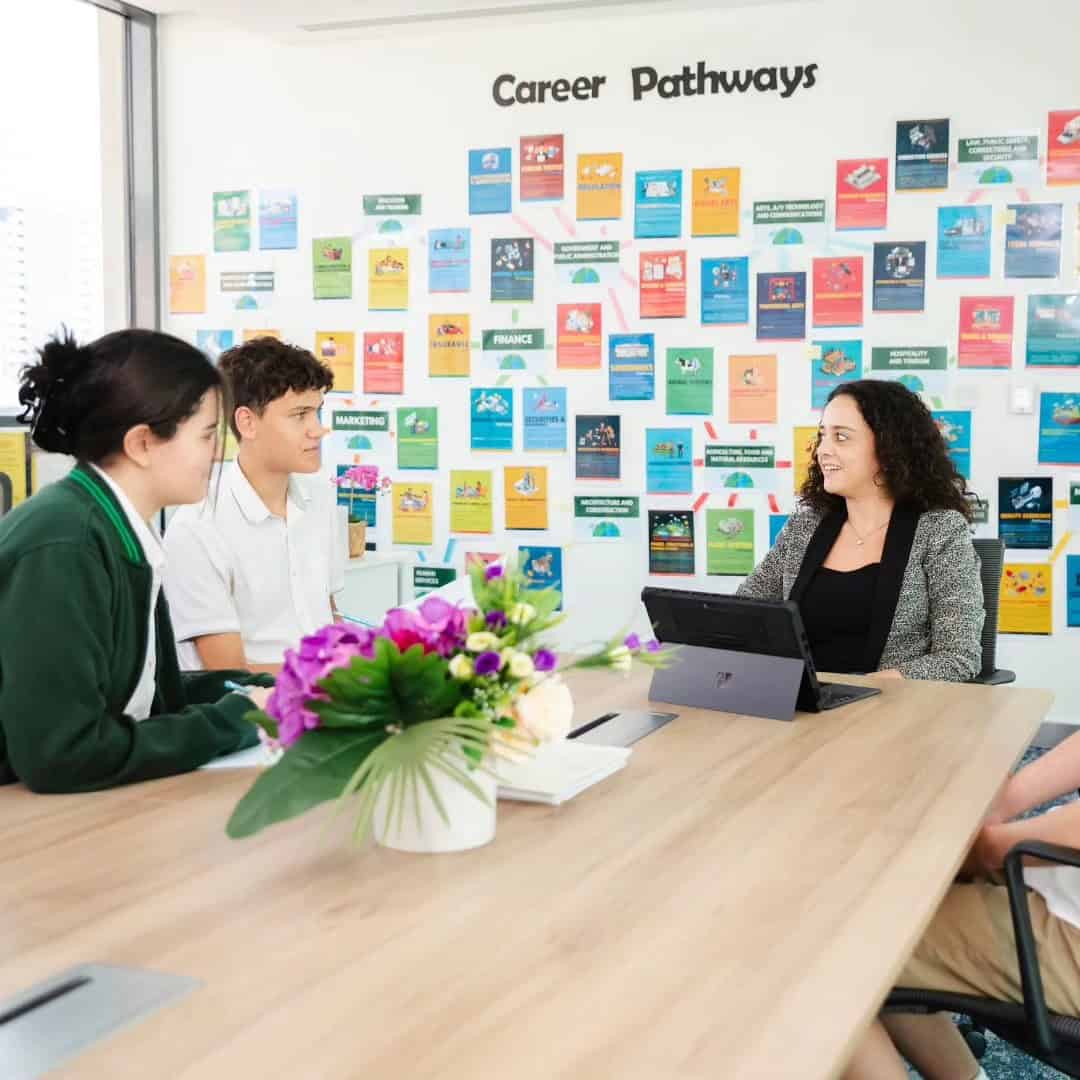 Students discussing career options with counselor in a classroom setting.