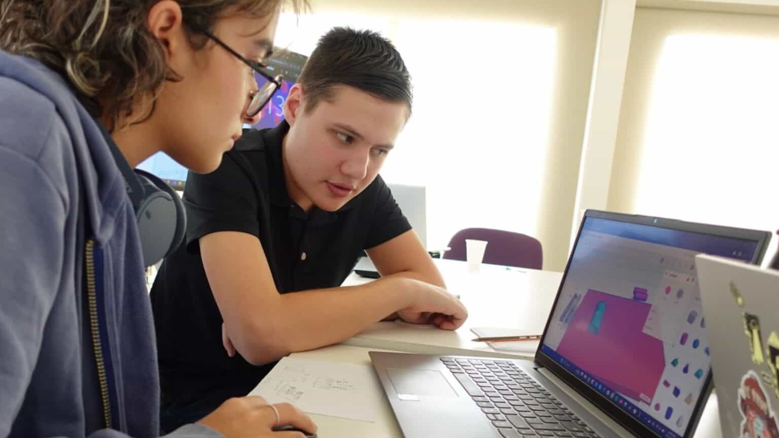 Innovative school students collaborating on digital design projects at World Schools.