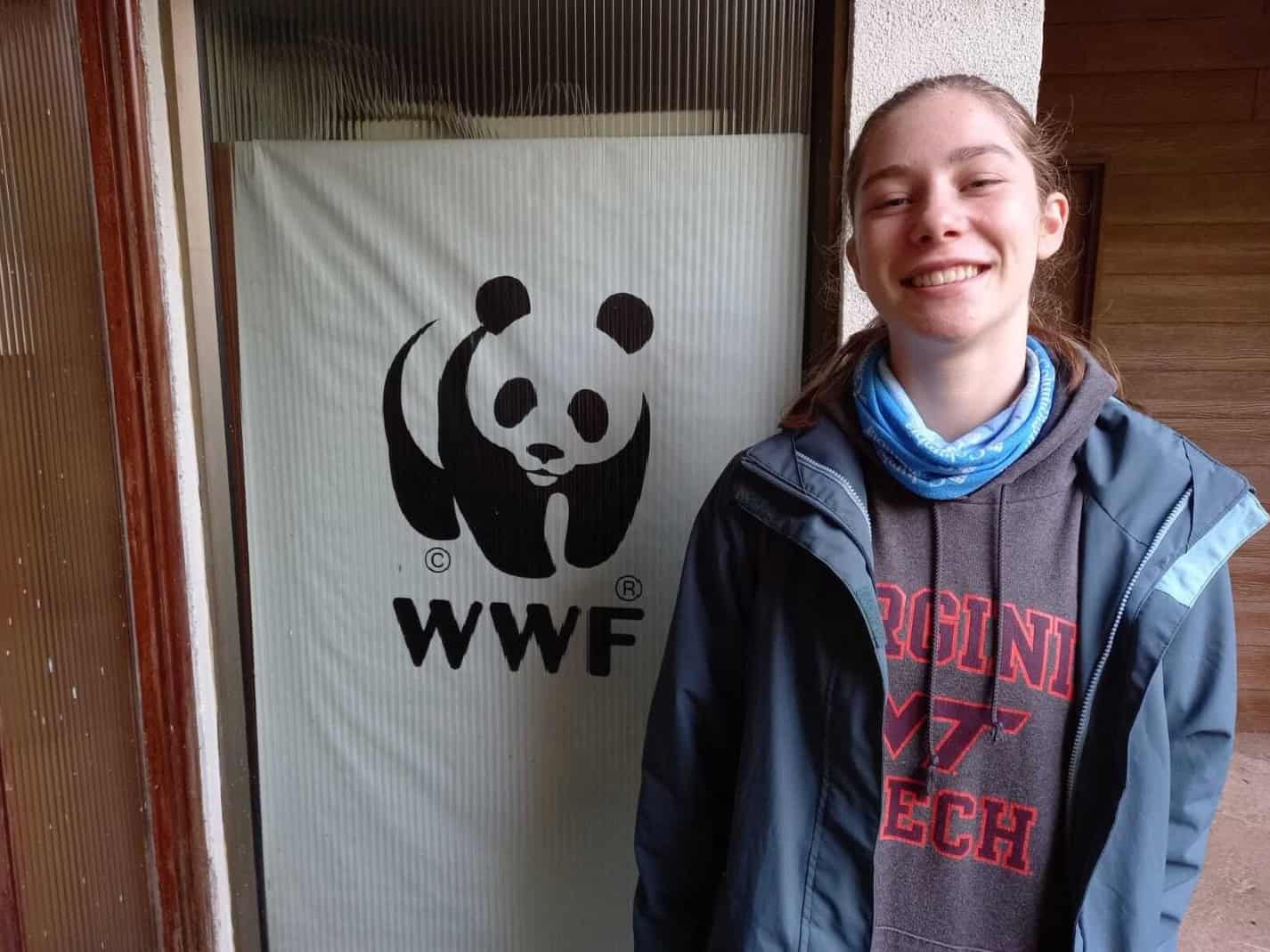 Environmental conservation at a WWF event with students and panda logo.