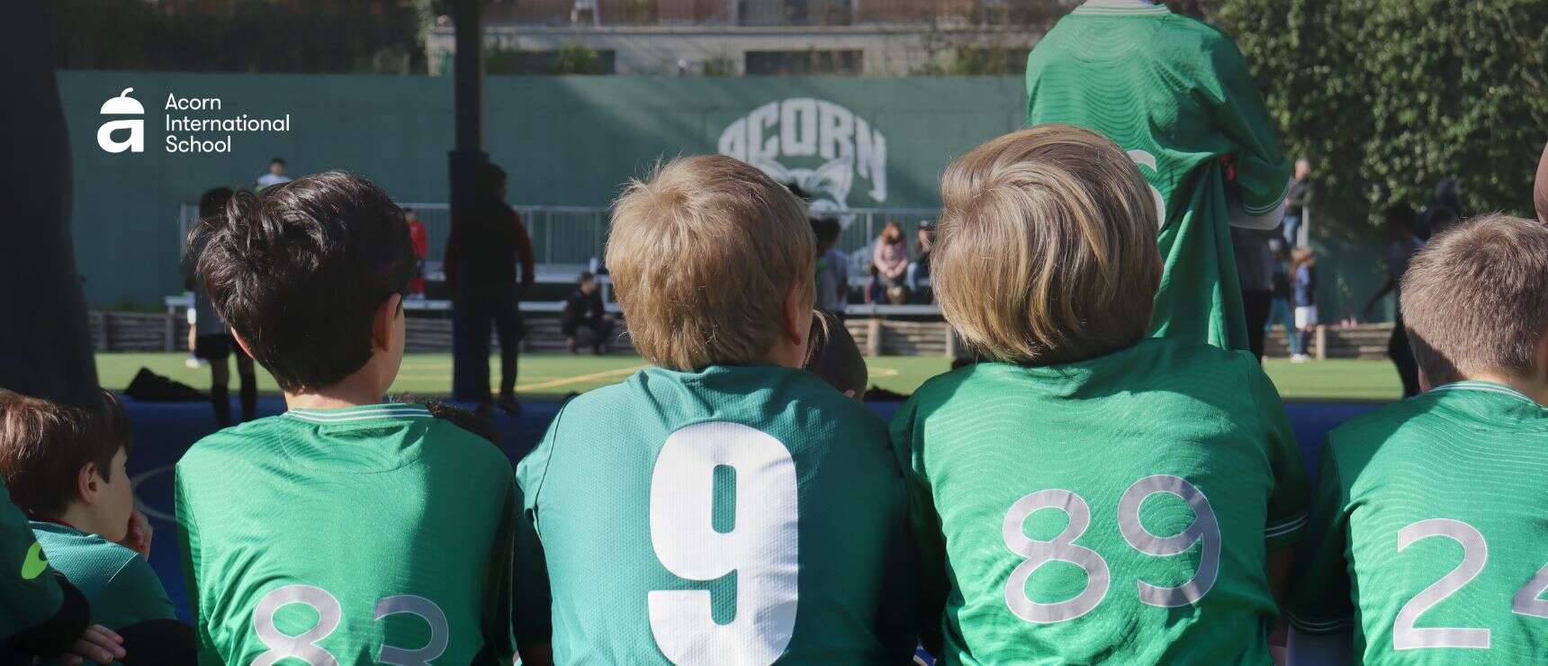 RISA Cup at Acorn International School: when sport becomes international education 3 Youth soccer team sitting on the field during a match at World Schools.