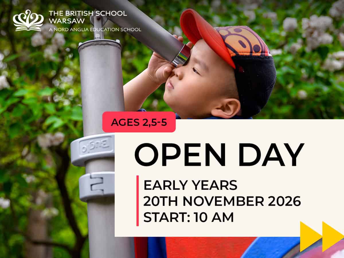 Young child looking through a telescope during open day event at The British School Warsaw.