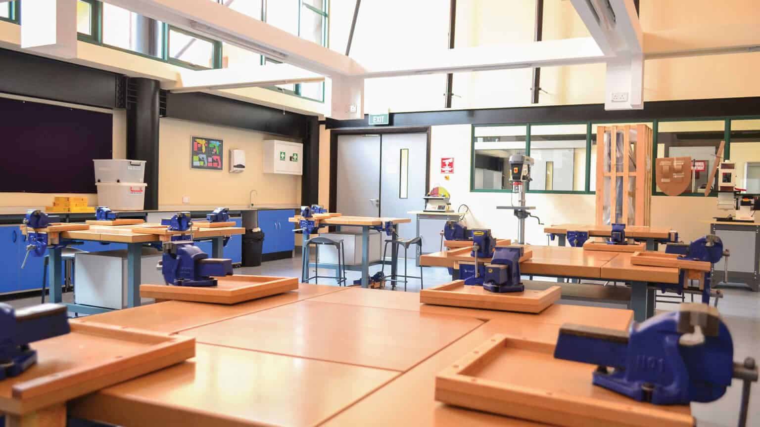 Modern school workshop with woodworking benches and tools for hands-on learning and skill development.