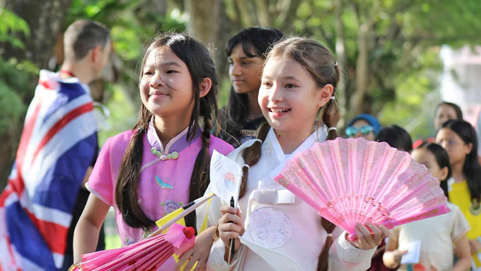 Joyful multicultural students celebrating cultural diversity at World Schools international event.