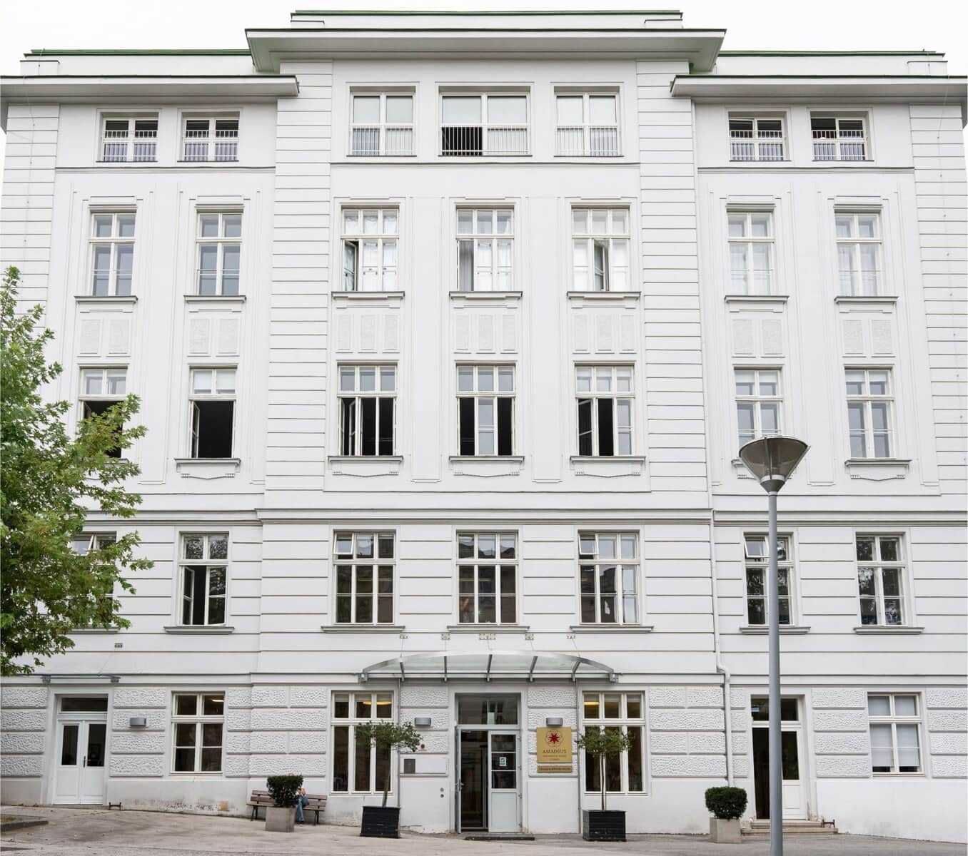 Modern white school building with large windows, ideal for international students and global education programs.