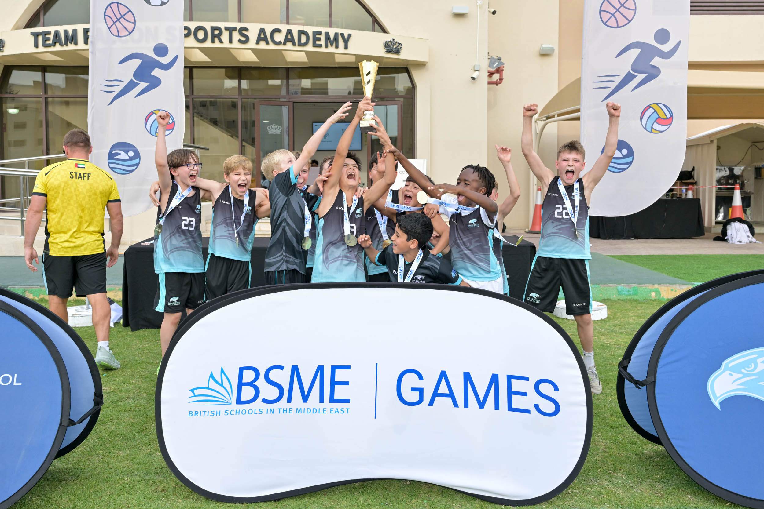 Young athletes celebrating victory at World Schools sports event.
