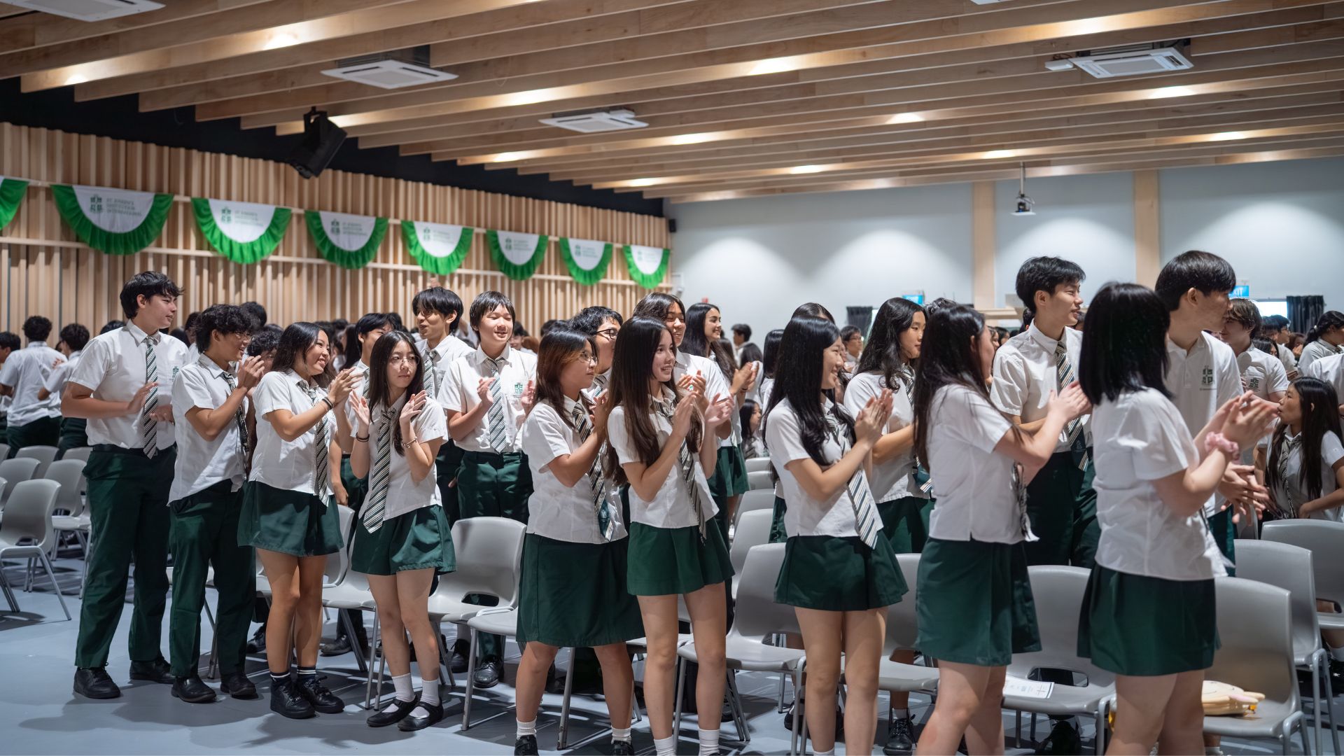 Group of students at school assembly in uniform.