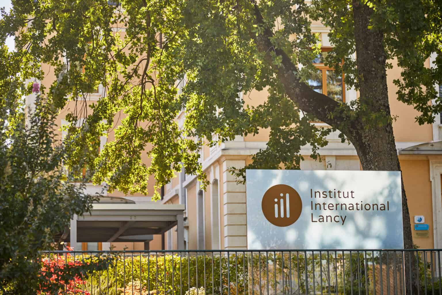 Modern international school building with greenery, part of World Schools network, promoting global education excellence.