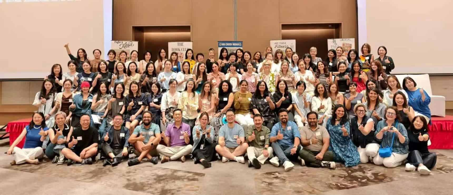 Diverse group of educators attending a world schools conference promoting international education excellence.