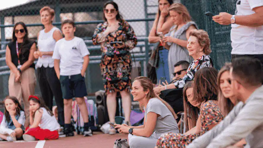 Group of students and teachers gathered outdoors at a school event.