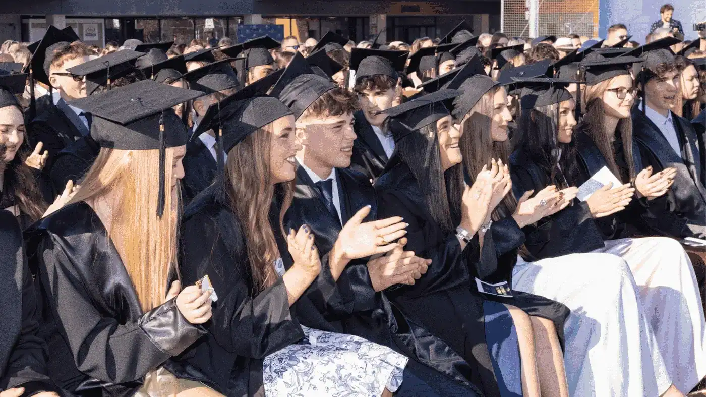 Students in graduation caps and gowns at a World Schools event.