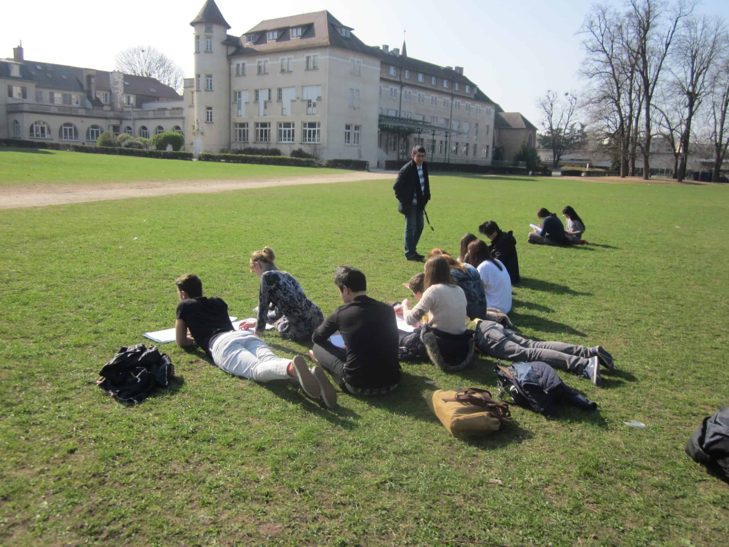 Students studying outdoors at a scenic World Schools campus.