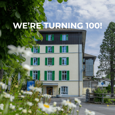 Historic World Schools building with green shutters and modern design elements.
